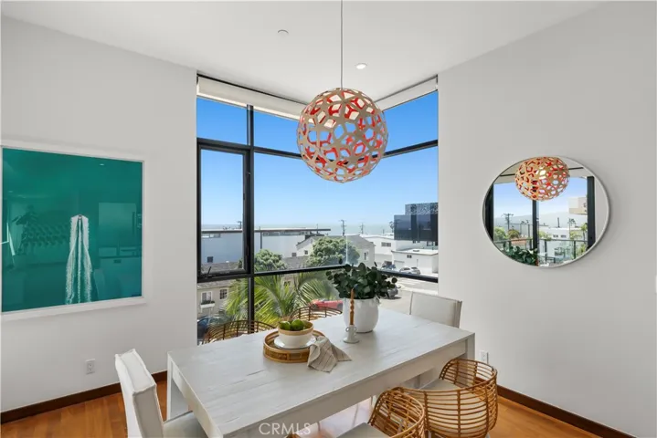 Dining area with mitered corner window offers glimpses to the north