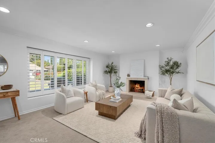Bright living room with a fireplace and classic shutters