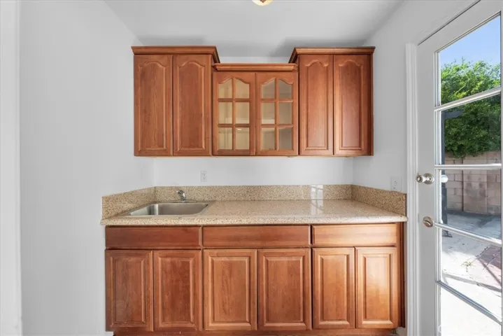 A beautiful wet bar in this versatile bedroom staged as an office