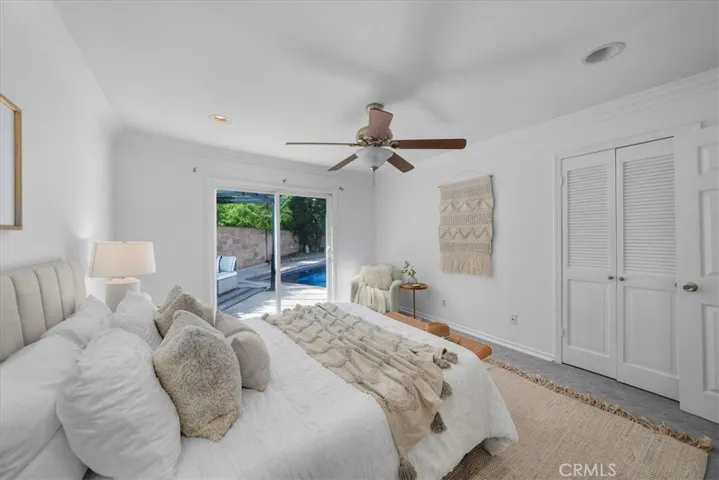 Primary bedroom with access to the pool and backyard