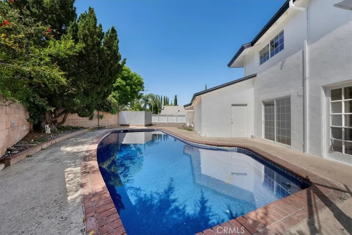 Swimming pool with multiple access to the house including to primary bedroom