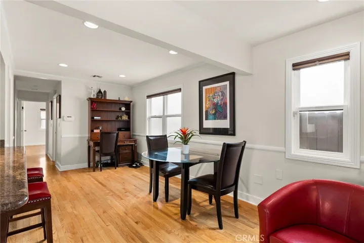 Den area with table, chairs and desk area.