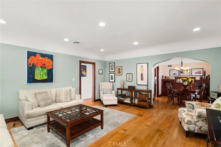 Livingroom with great detail.  Wooden doorways and scalloped opening to the dining room.