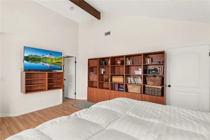 Primary Suite with built-in storage cabinets for display items.