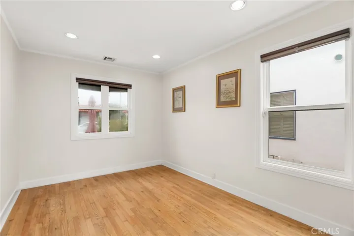 First floor guest bedroom with windows and a large closet.