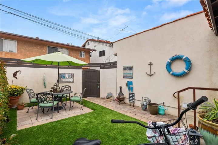 Backyard with door to the ally.