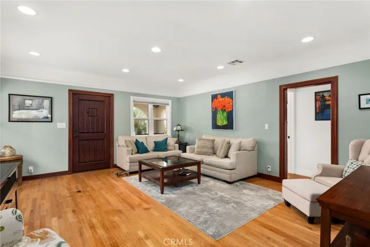 Livingroom, two windows and wooden floor.