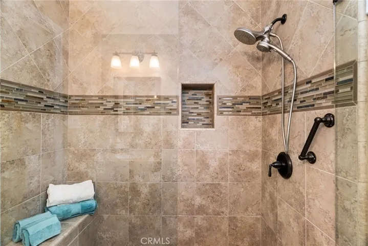 Guest bath step in shower with bench.