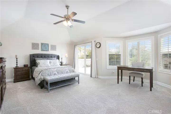 Primary suite with ceiling fan & sitting area