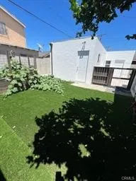 Backyard with Artificial Turf & Fenced Veggie Garden