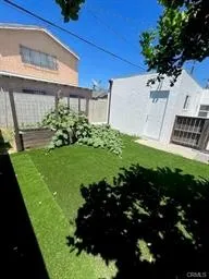 Backyard with Artificial Turf & Fenced Veggie Garden