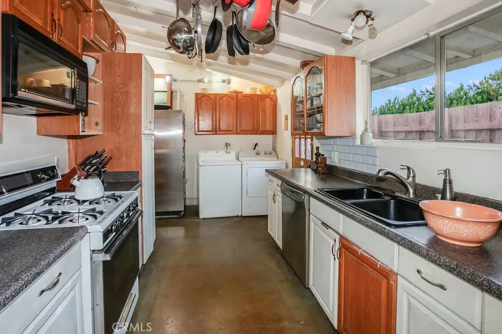 The cook in the family is going to appreciate the kitchen with its sparkling window, abundant cabinetry, handy pantry, dual basin sink, gas range, microwave, stainless steel refrigerator, stainless steel dishwasher and concrete floors.