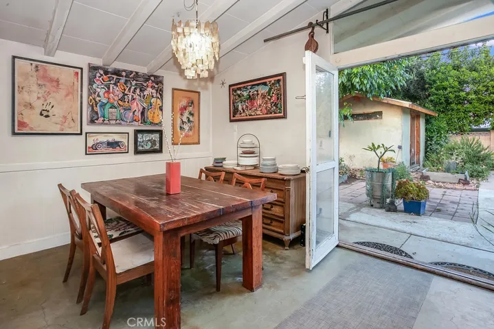 The dining room fittingly adjoins the kitchen and with its pitched beam ceiling, drop-down lighting and framed glass doors that lead to the backyard, it is perfect for any occasion.