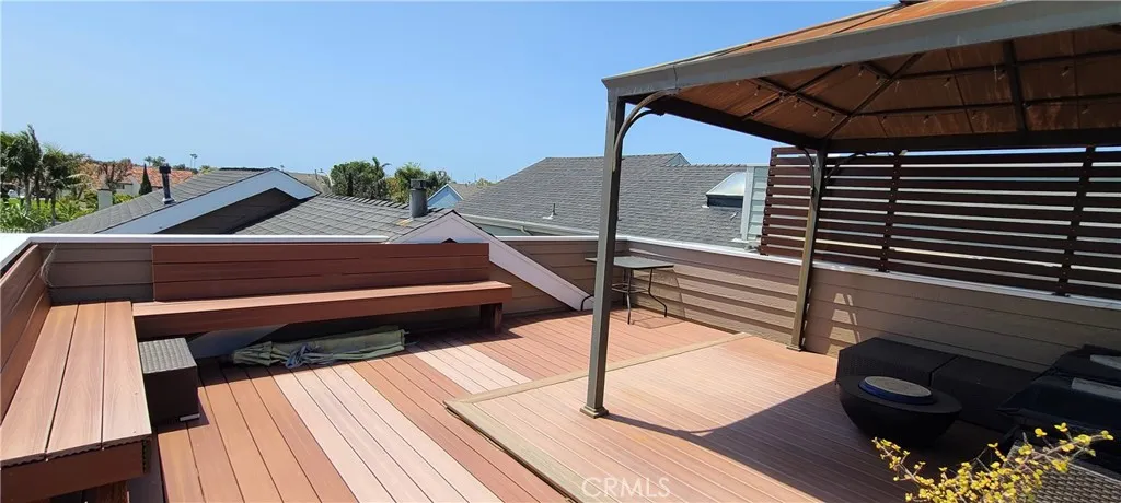 Upper, open-air view deck with plenty of seating for relaxing or entertaining. Views of the Huntington Beach annual fireworks show and air show can be seen from the deck.