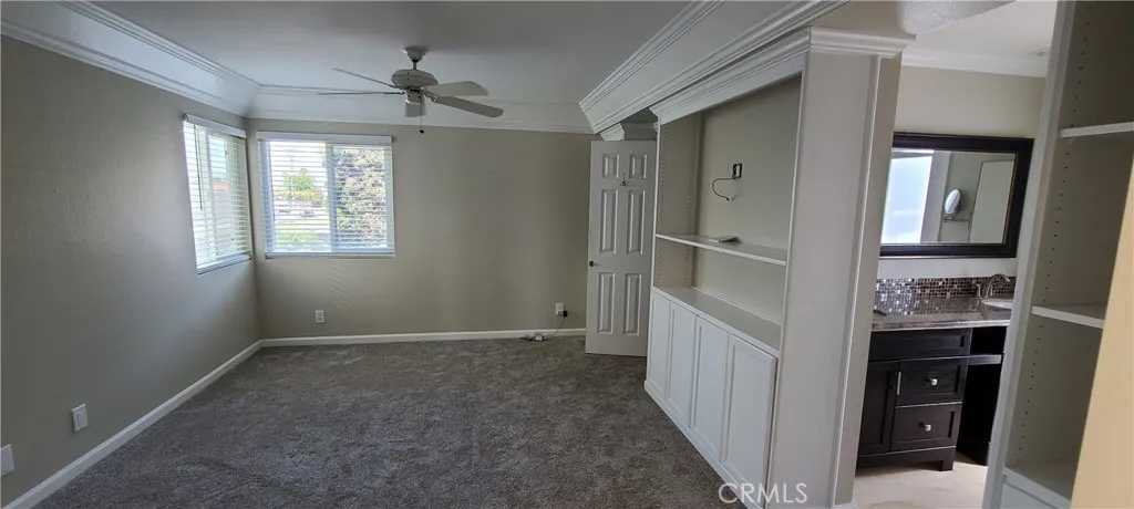 Primary bedroom with walk-in closet, ensuite full bathroom and direct access to spiral staircase leading to the upper view deck.