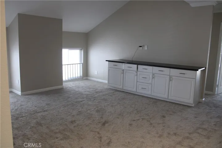 Large upstairs loft with built-in cabinetry.