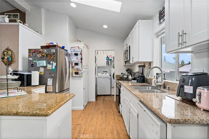 Kitchen Area with Laundry Area View and Skylight