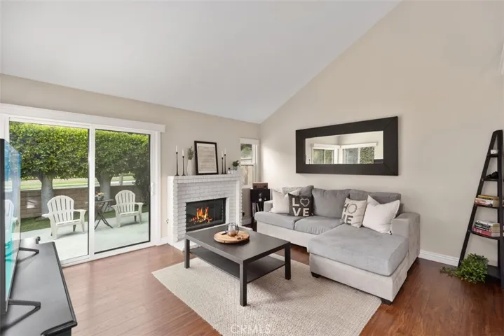 living  with vaulted ceiling and fireplace