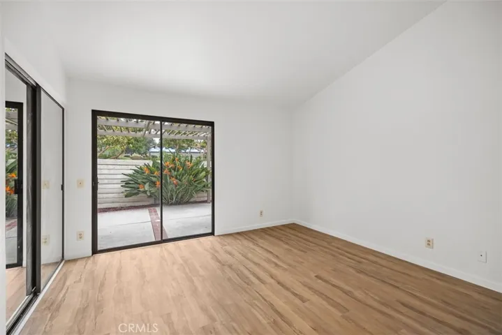 Primary bedroom, vaulted ceiling, view and access to the patio