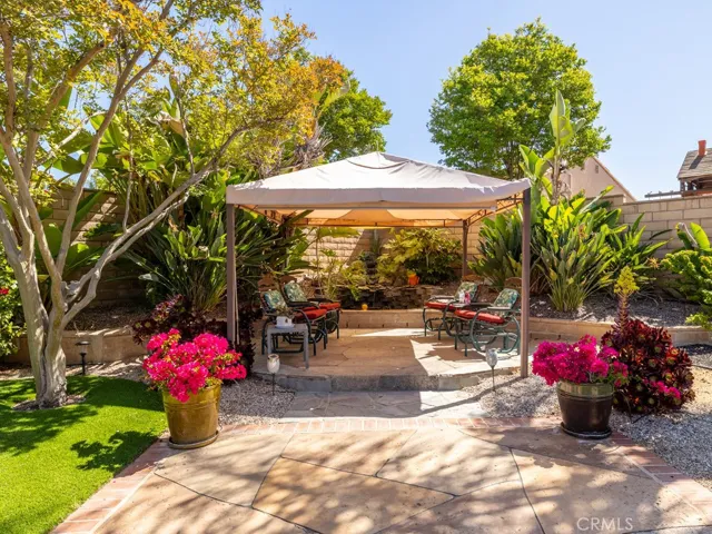 Backyard covered seating area with pond