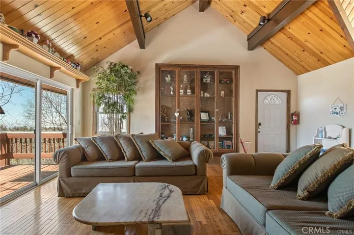 Living room area with antique hutch and deck access.