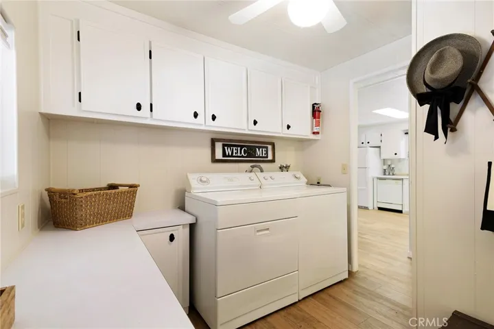 Laundry/Utility room with extended storage areas, with a door to both the common bath and carport