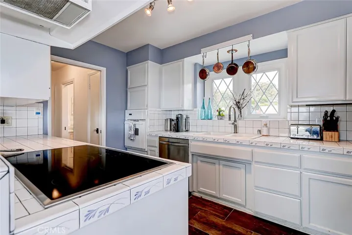 Kitchen with doorway leading to laundry area and 1/2 bath