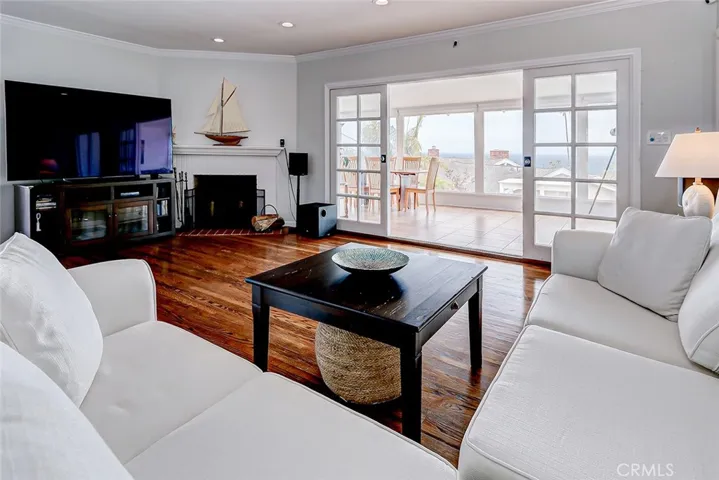 View of living room facing sunroom, backyard, and view