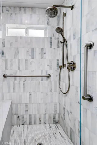 Master shower with elegant marble tiles