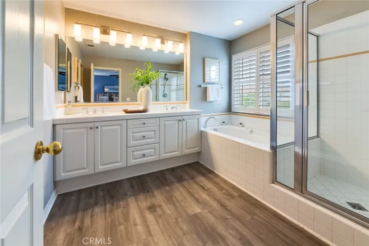 Primary Bathroom with Dual Sinks and Separate Tub and Shower