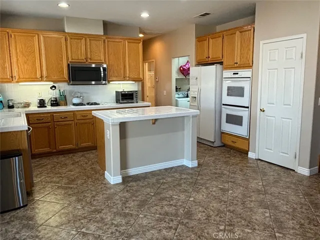 Kitchen with double ovens and walk in pantry