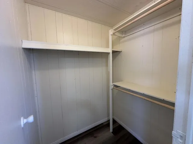 Master walk in closet with new shelves