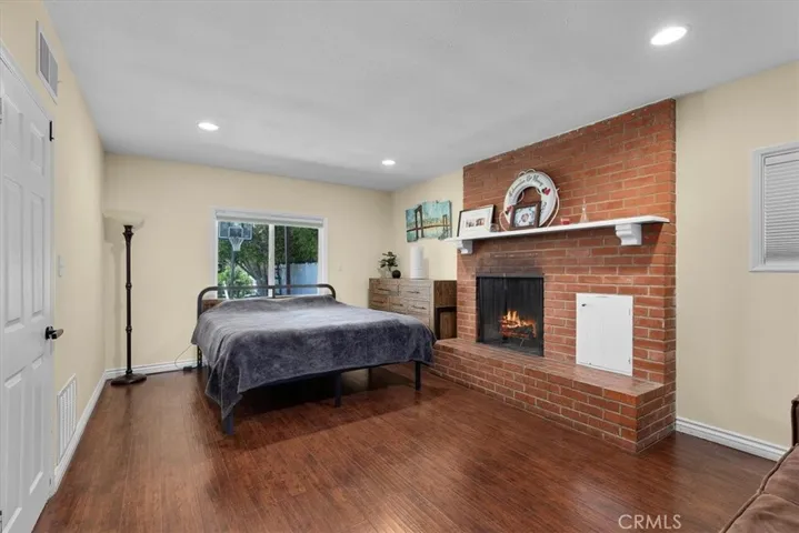 Primary bedroom with wood burning fireplace