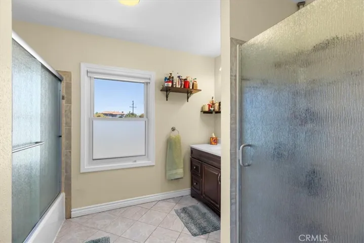 Large bathroom upstairs with standing shower as well as tub shower combo