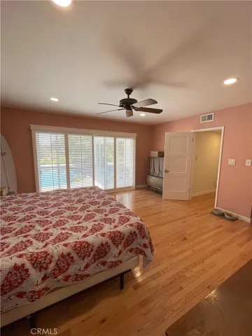Primary bedroom with window view out to pool