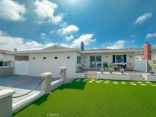 Front of home with 2-car driveway apron, front yard, front Trex deck - great curb appeal!