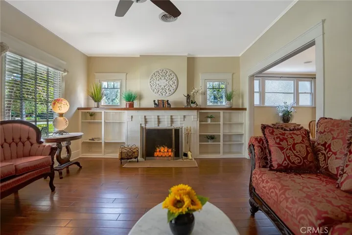 Living area with built ins, fireplace, light and bright with many windows