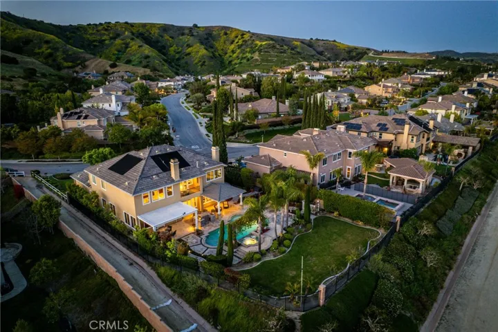 Lot size includes slope/HOA landscape easement beyond wrought iron.