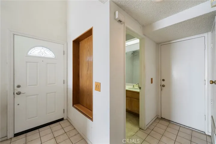 Art niche in the foyer...powder room and direct access to the 2 car garage.