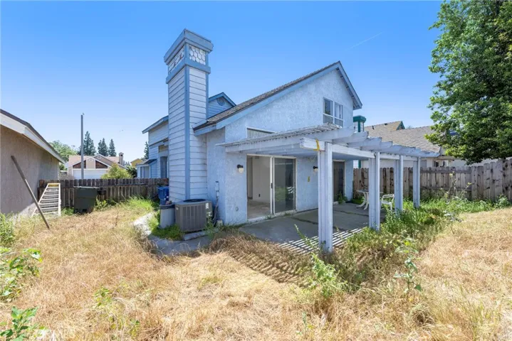 Views of the side yard, back patio/yard, and the back of the home. Property is on a zero lot line!