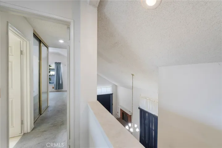 Hallway at the top of the stairs with views of the primary suite and is open to the foyer, dining and living rooms!