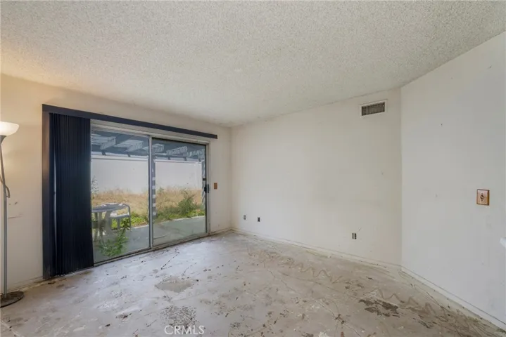 Family room with sliding glass door that opens to the back patio and yard!