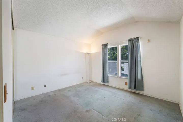 Primary bedroom has vaulted ceilings with window overlooking the backyard!