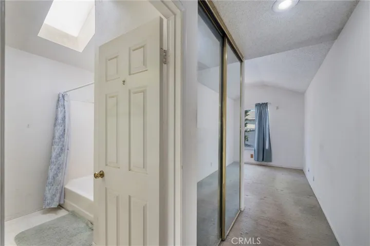 Entry into the primary suite with views of the primary en suite and one of the two primary bedroom closets!