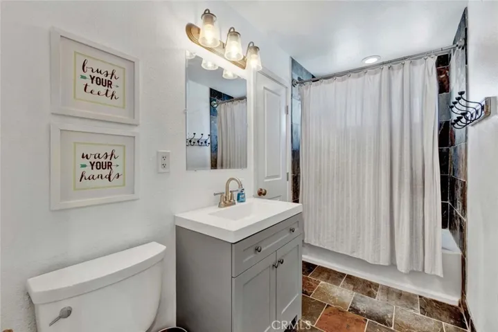 Upstairs Bathroom has Newer Vanity, Slate Tile Surround, Bath/Shower Combo, and there is a Walk-In Closet in this Bathroom