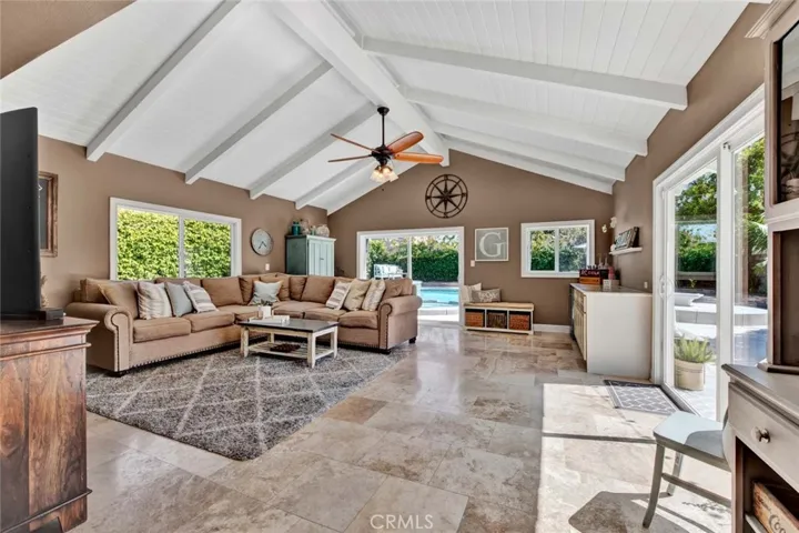 Amazing Family Room Addition with Open-Beam Cathedral Ceiling, Travertine Flooring, Marble Dry Bar, and 2 Sliders to Paradise Backyard