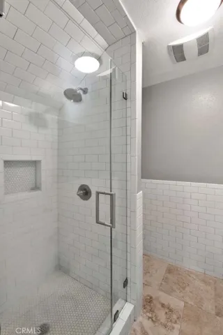downstairs Bathroom has Walk-In Shower with Subway Tile Surround and Subway Tile Wainscoting on Walls