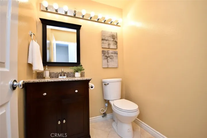 Downstairs powder room with remodeled cabinetry and counter.