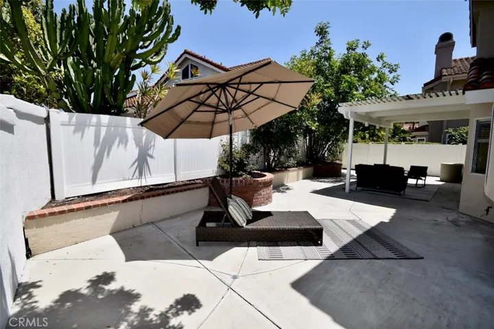 Large backyard with newer PVC style fencing.