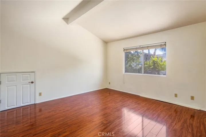 Master bedroom without staging- door to attic storage in master bedroom